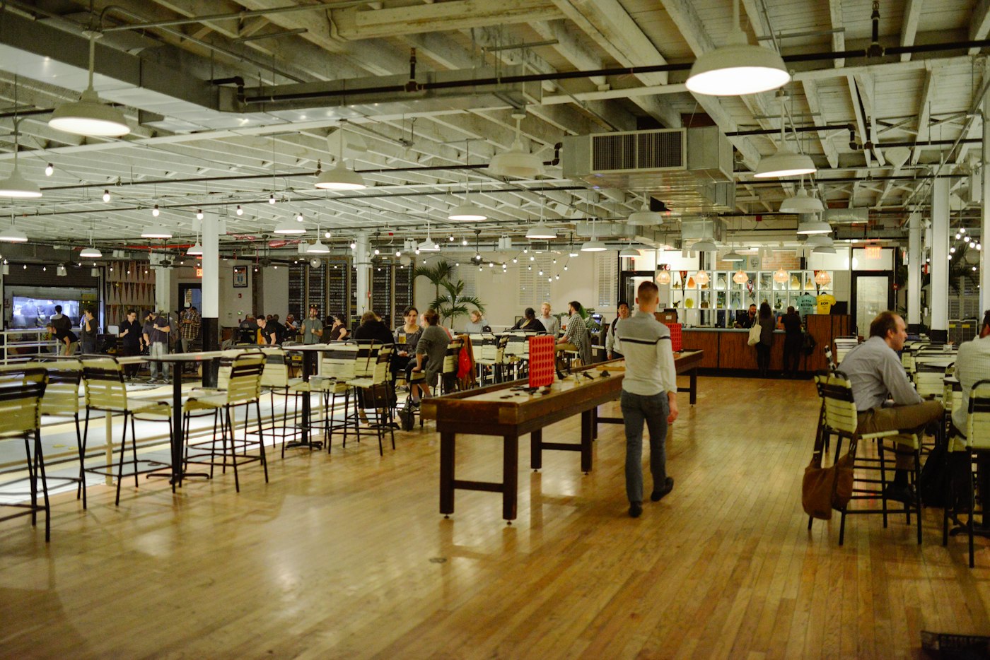 A restaurant with open seating and spaces for guests to gather